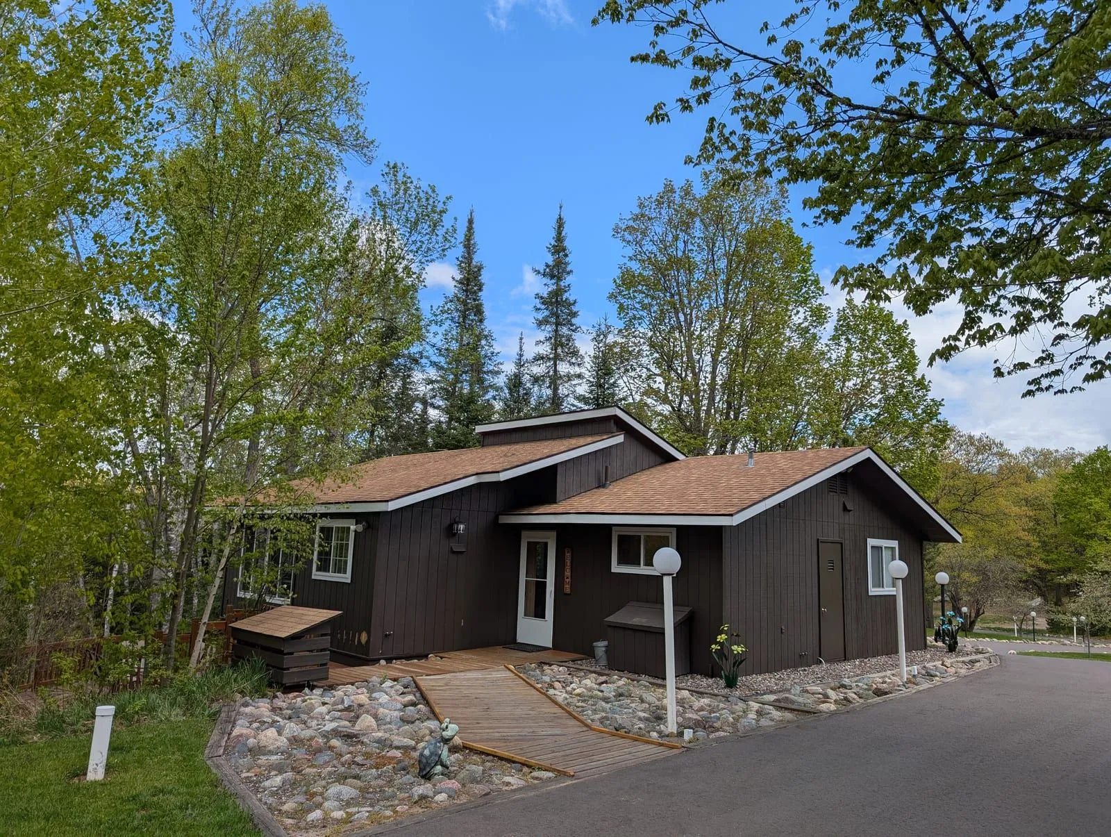 Rustic Fawn with dark siding and birch trees