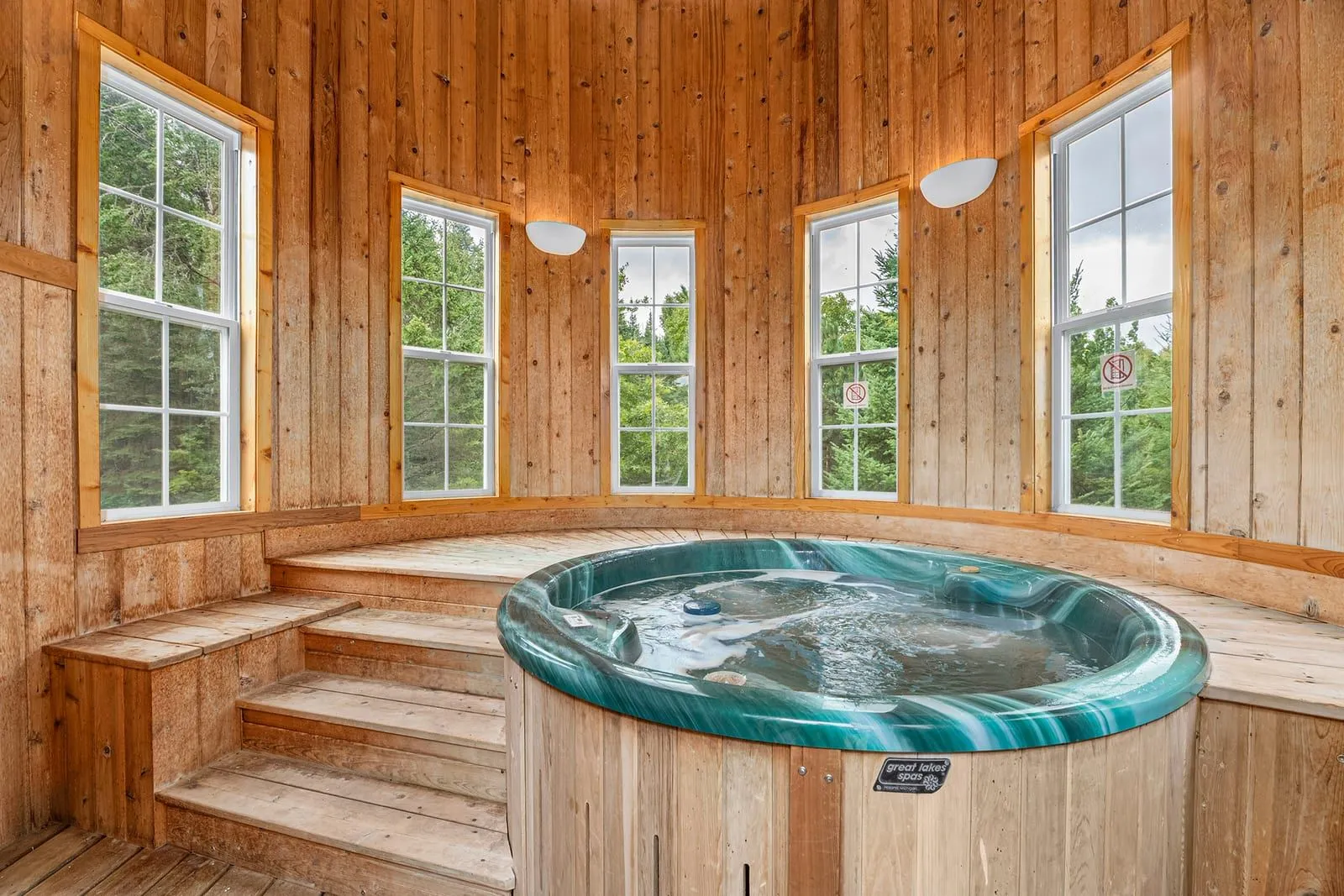 Silo hot tub interior with panoramic forest and lake views