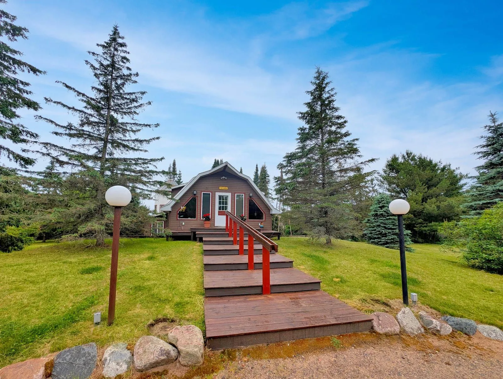 Harlequin Haven front entrance with globe lights and walkway