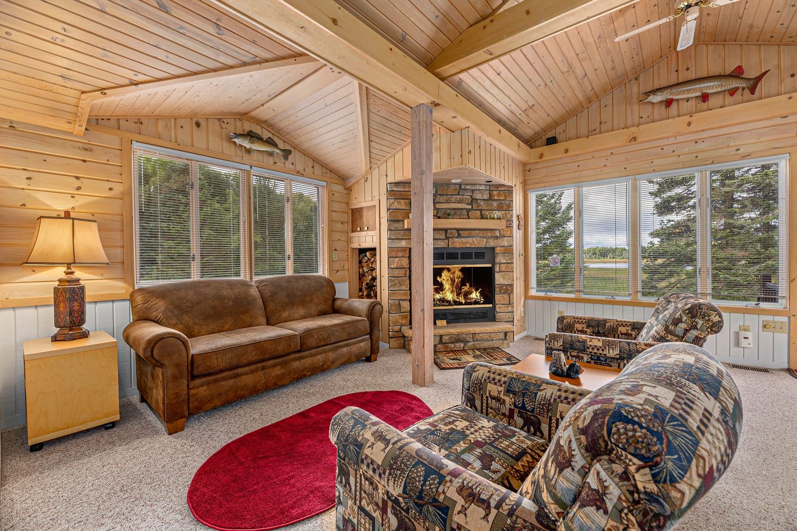 Open living area with stone fireplace and Northwoods decor