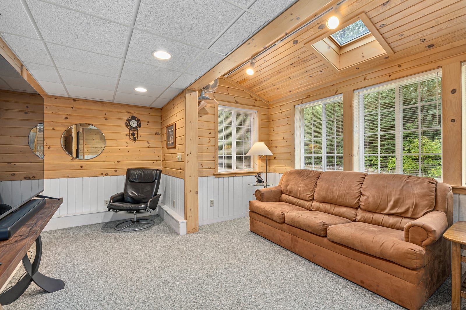 Lower level den with sofa and pine walls