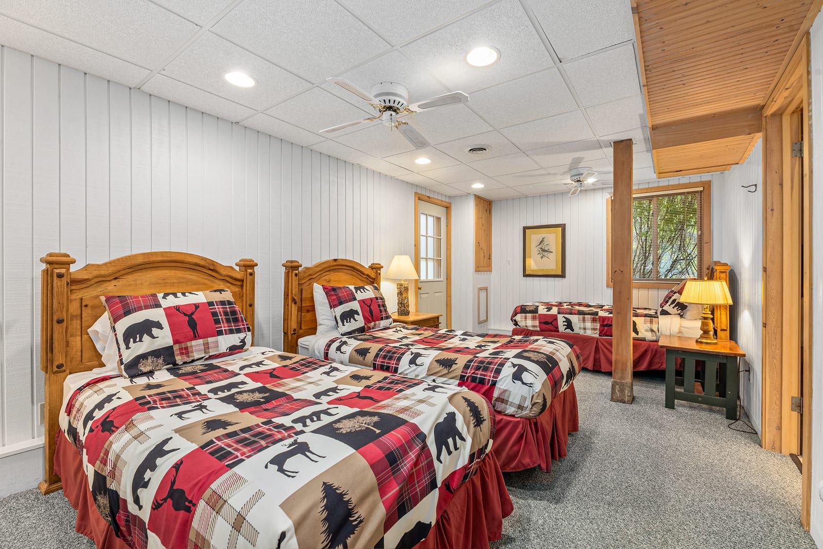 Twin bedroom with two beds and wildlife-themed bedding