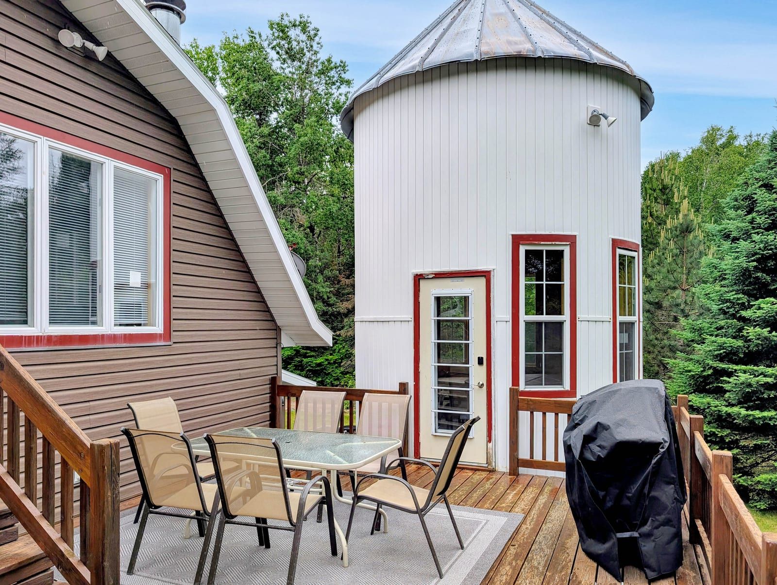 Deck with dining table and silo hot tub building
