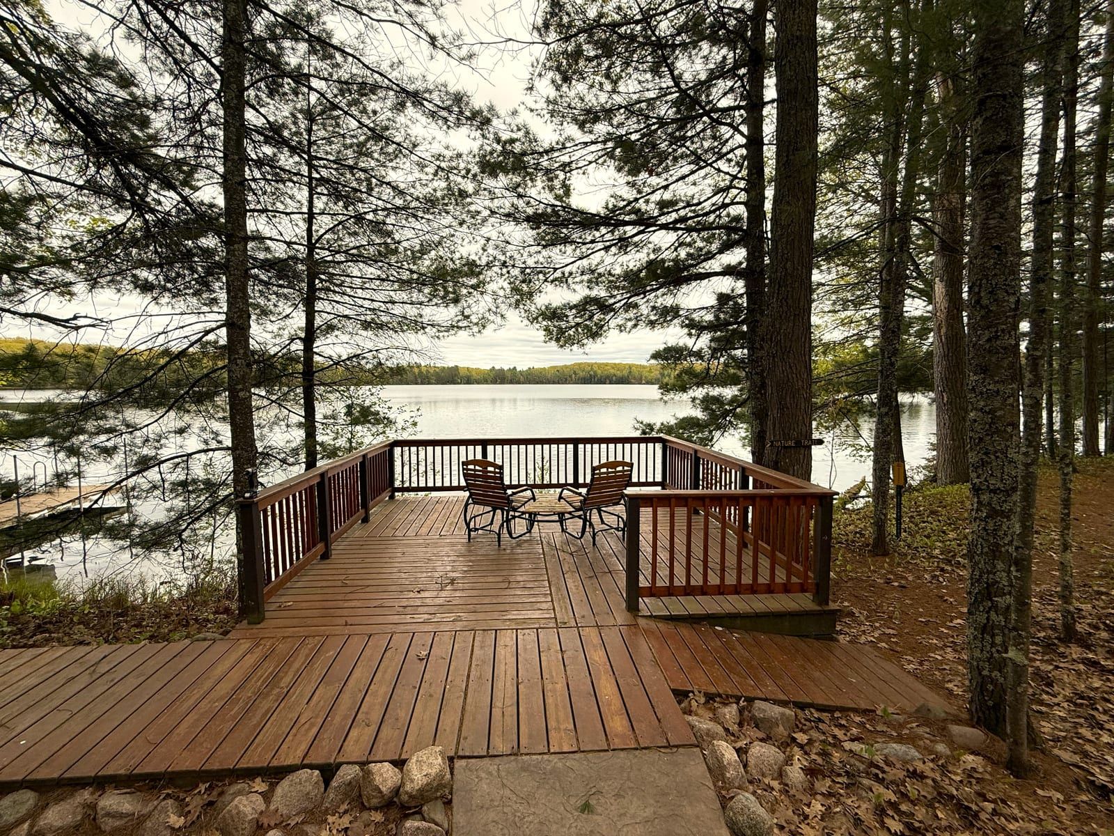 Lakeside viewing deck among pines in autumn