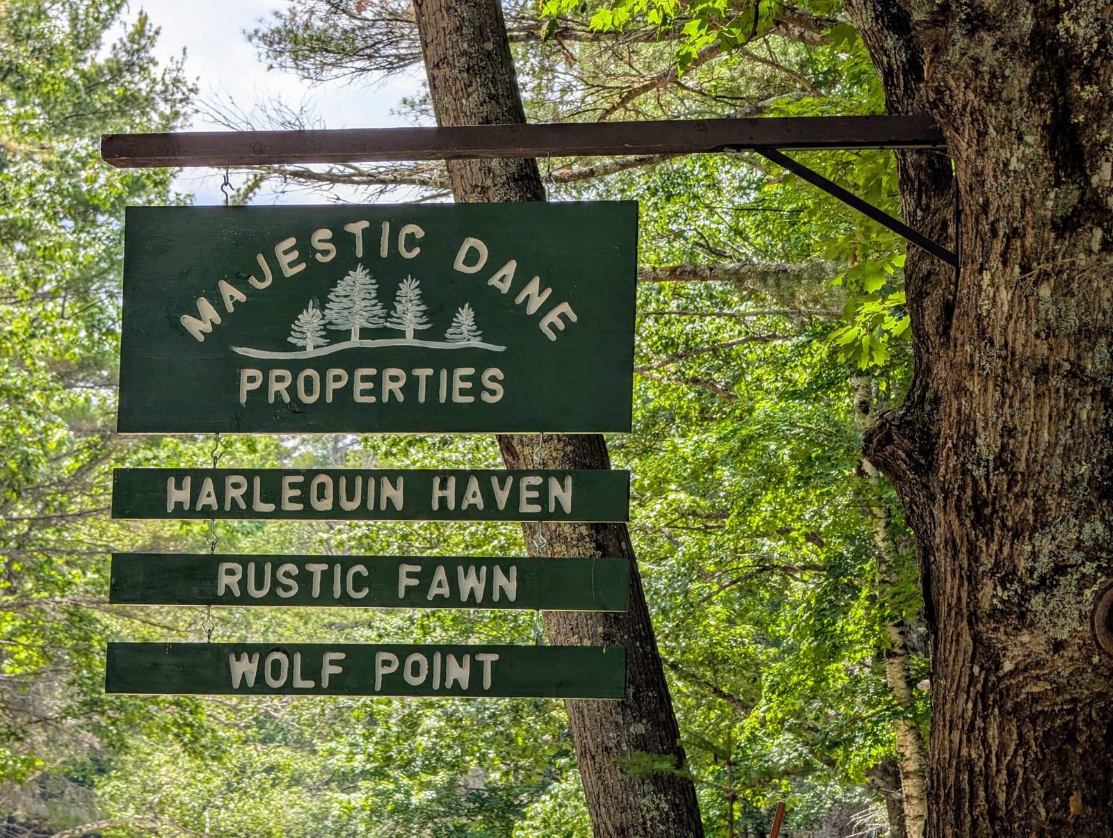 Majestic Dane Properties sign for Harlequin Haven, Rustic Fawn, and Wolf Point