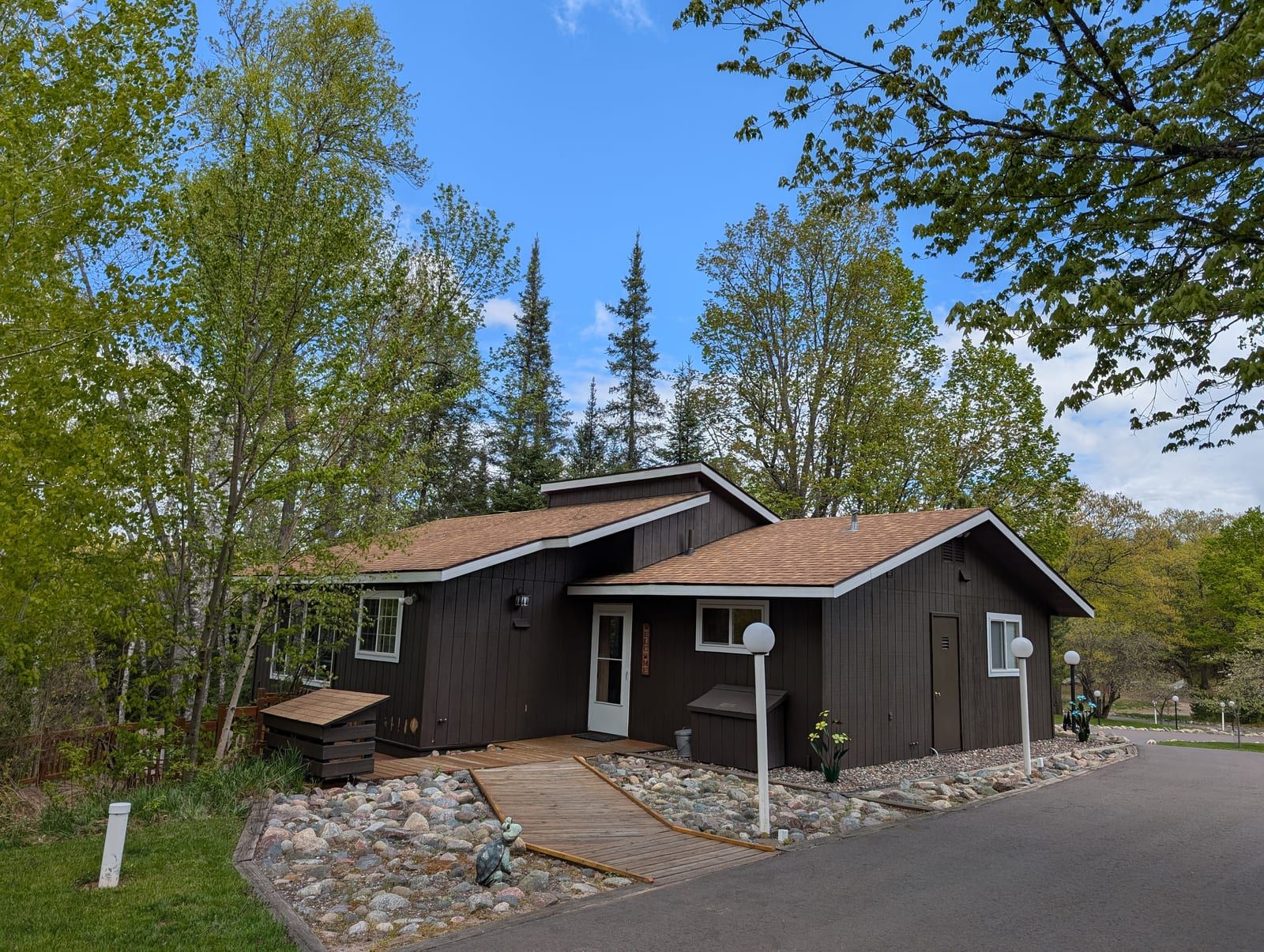 Rustic Fawn exterior with dark siding and birch trees