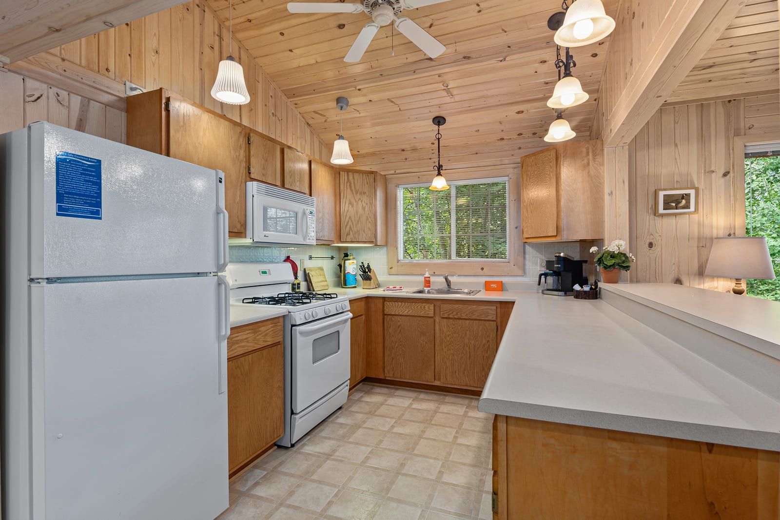Full kitchen with oak cabinets and pine ceiling