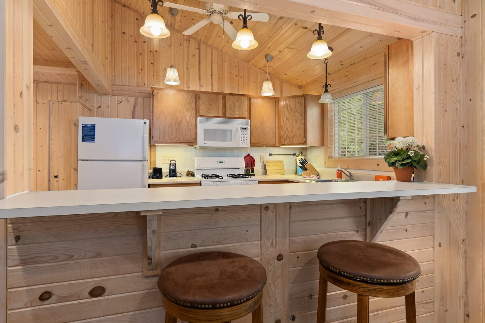 Kitchen with bar stools and breakfast counter