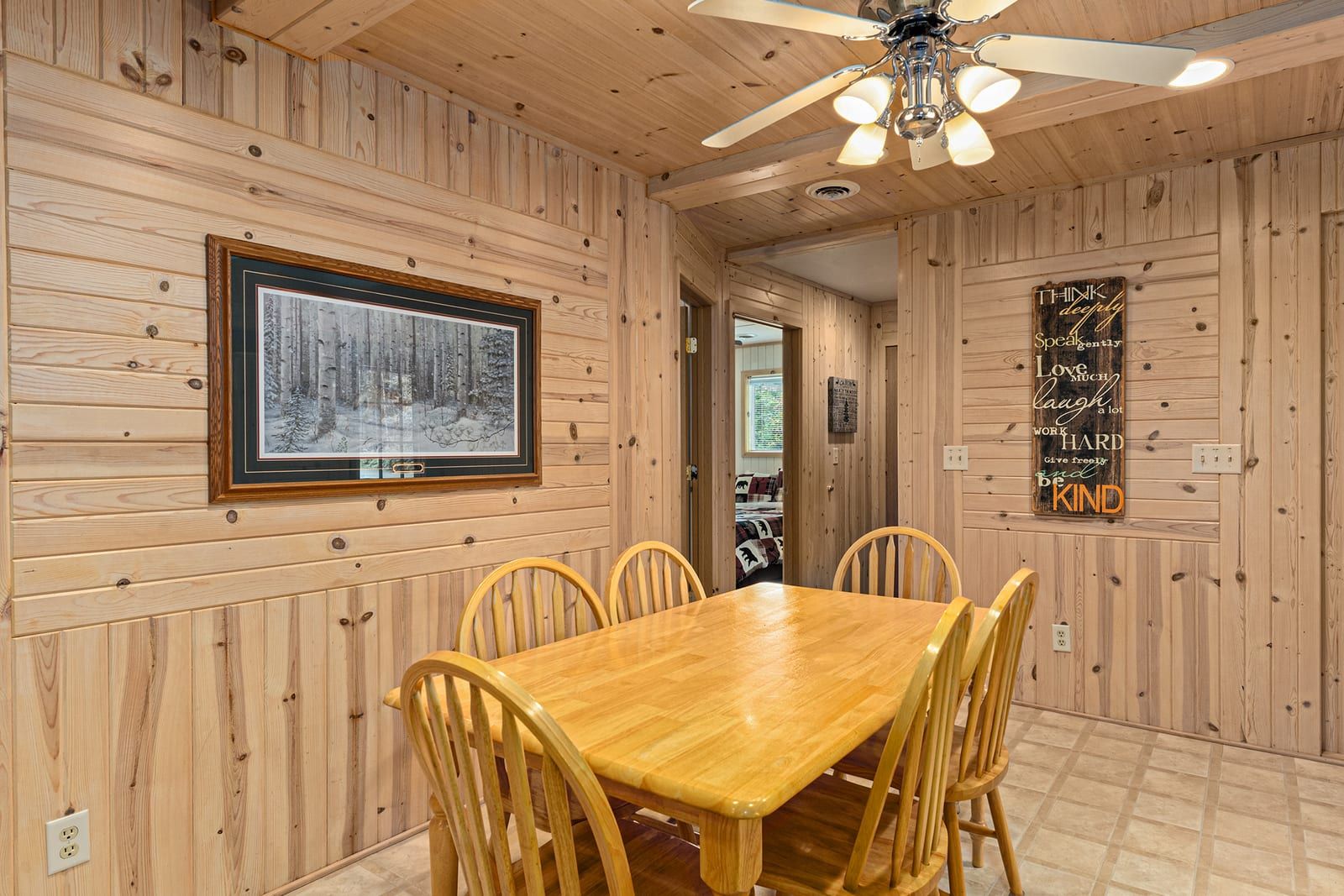 Dining room with pine walls and Northwoods artwork