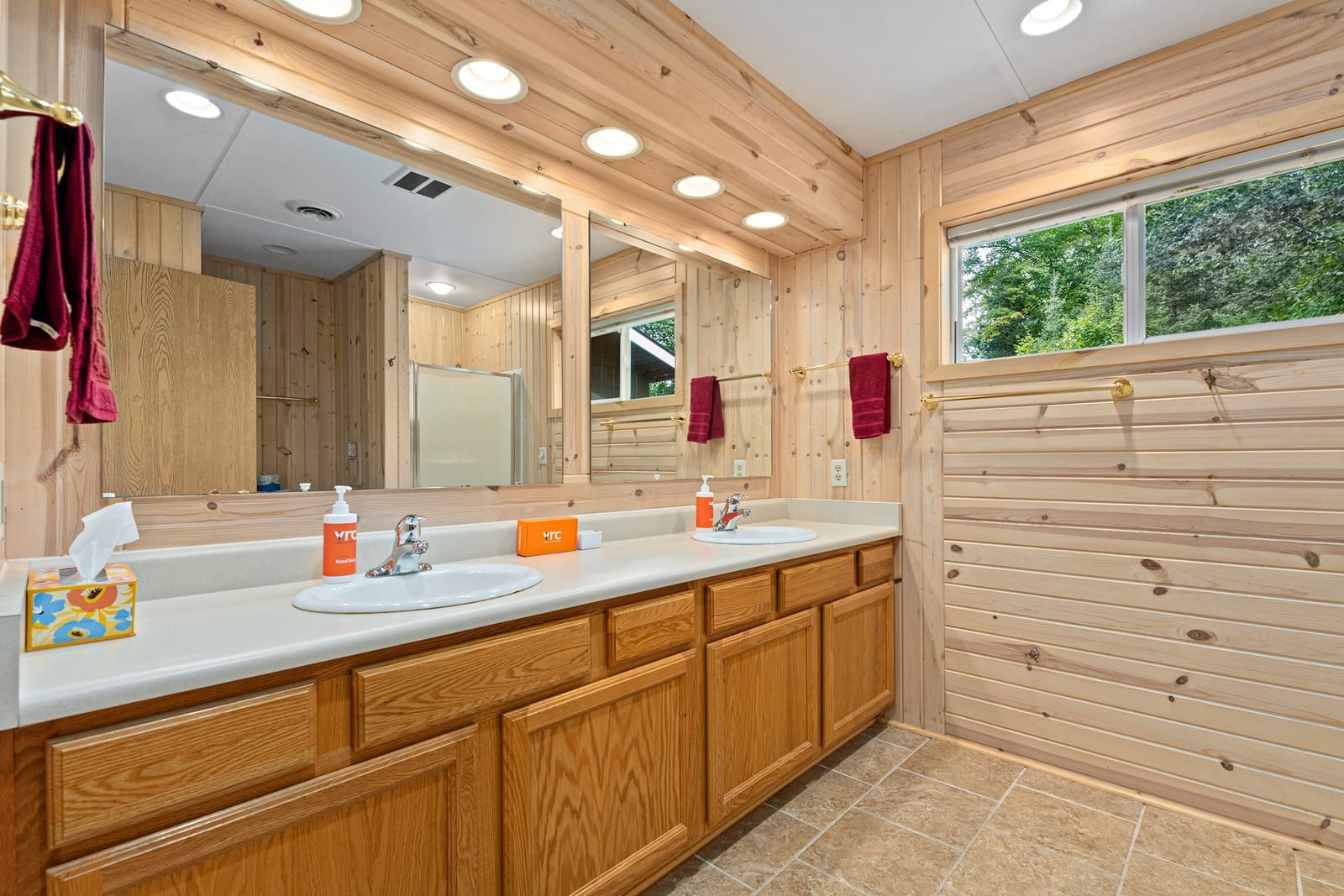 Bathroom with double vanity and pine wood accents