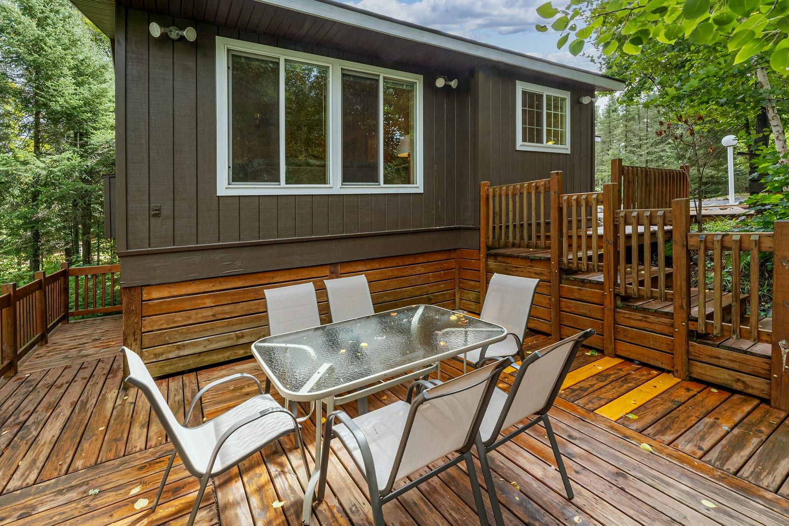Side deck with outdoor dining and forest views
